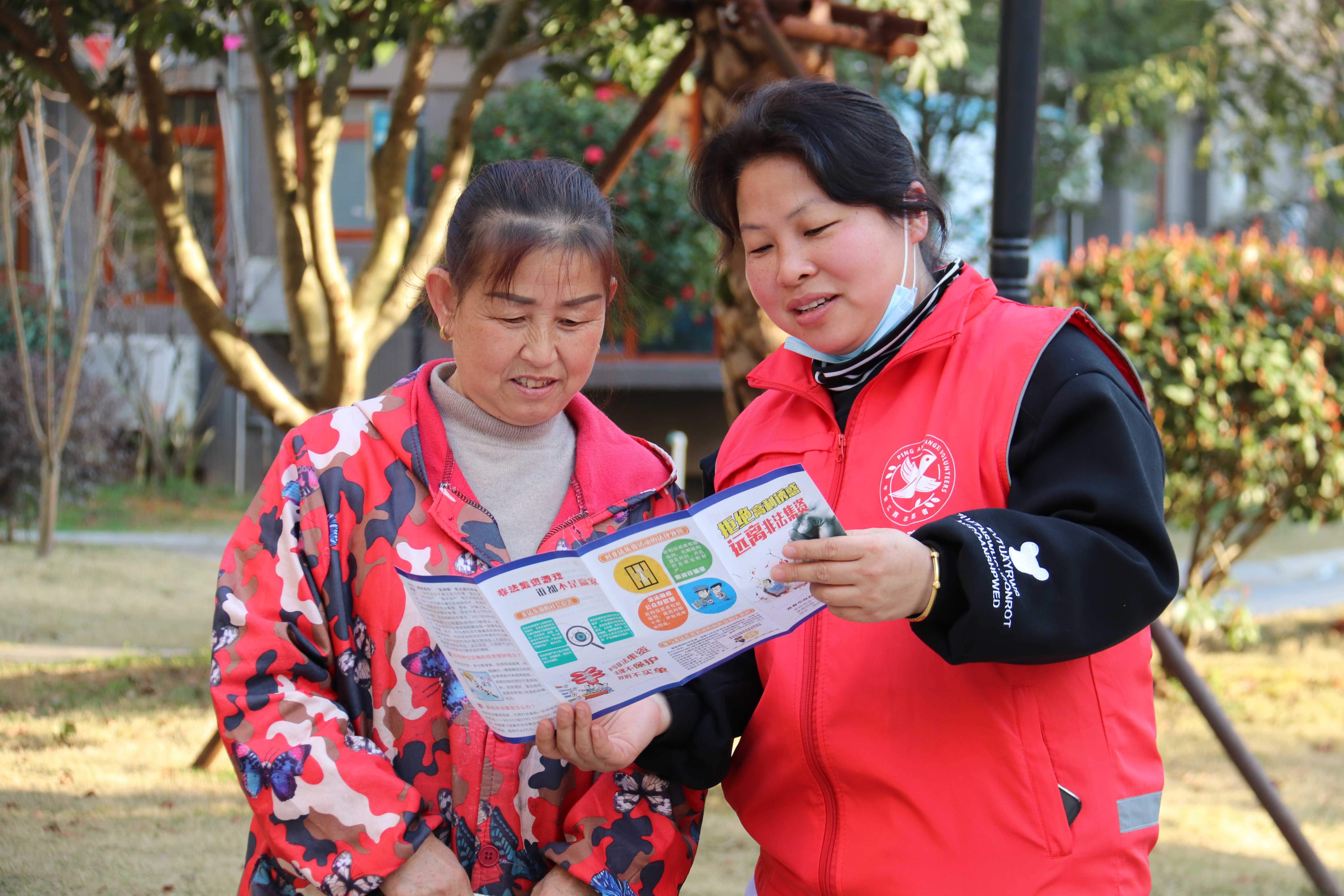 奉新县冯川镇蒋家堎社区志愿者在向辖区居民介绍防诈常识。（宋蓉 摄）